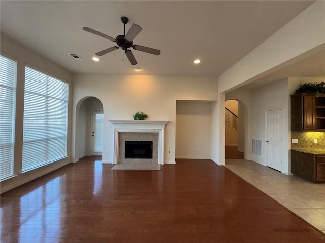 unfurnished living room with ceiling fan and light hardwood / wood-style floors