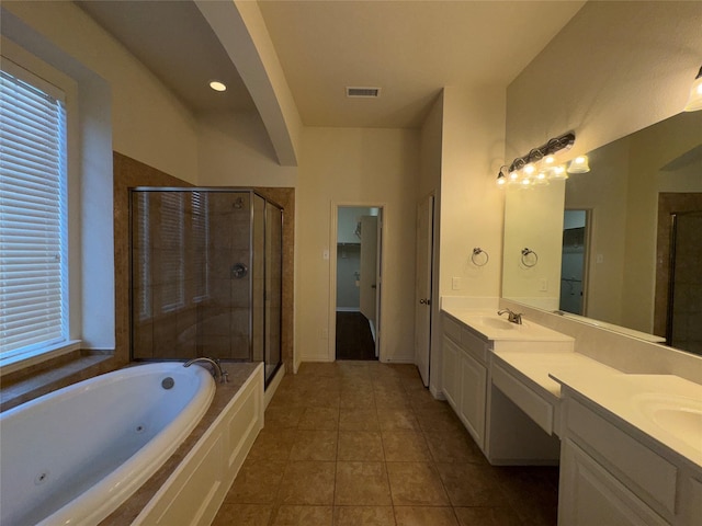 bathroom featuring vanity, separate shower and tub, tile patterned flooring, and a wealth of natural light