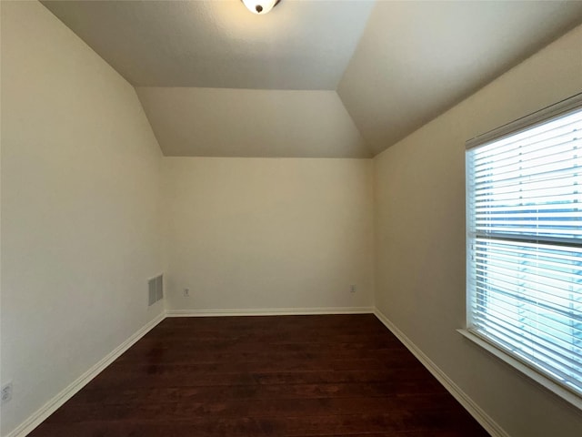 bonus room with lofted ceiling and dark wood-type flooring