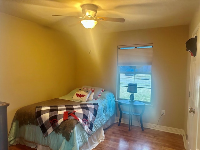 bedroom featuring hardwood / wood-style flooring and ceiling fan