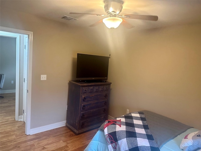 bedroom with ceiling fan and light hardwood / wood-style floors