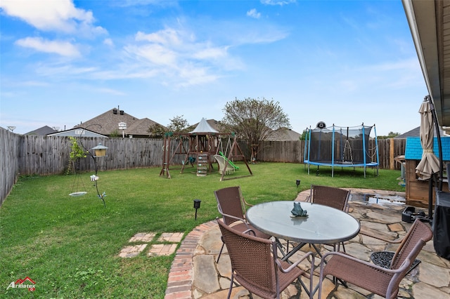 view of yard featuring a playground, a patio, and a trampoline