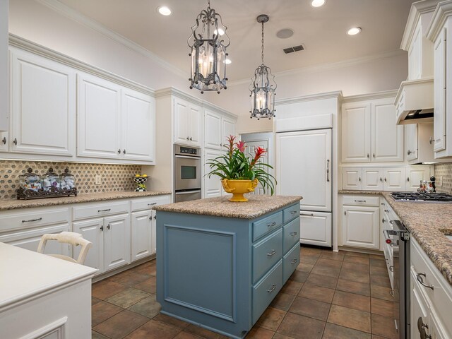 kitchen featuring crown molding, blue cabinets, a kitchen island, and white cabinets