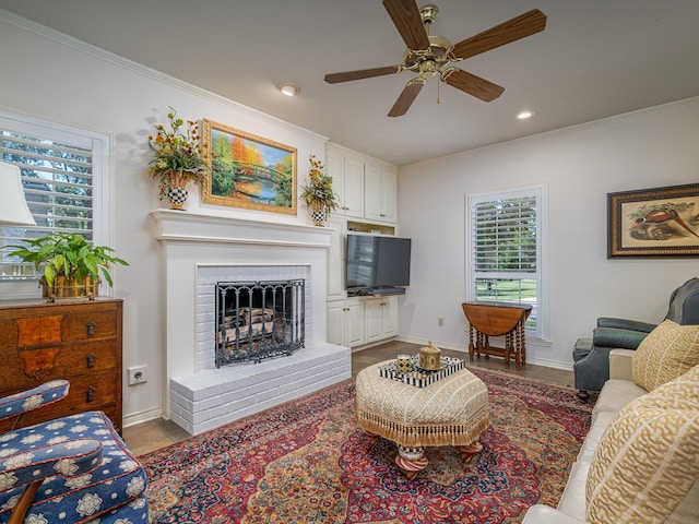 living room featuring a brick fireplace, ornamental molding, and ceiling fan