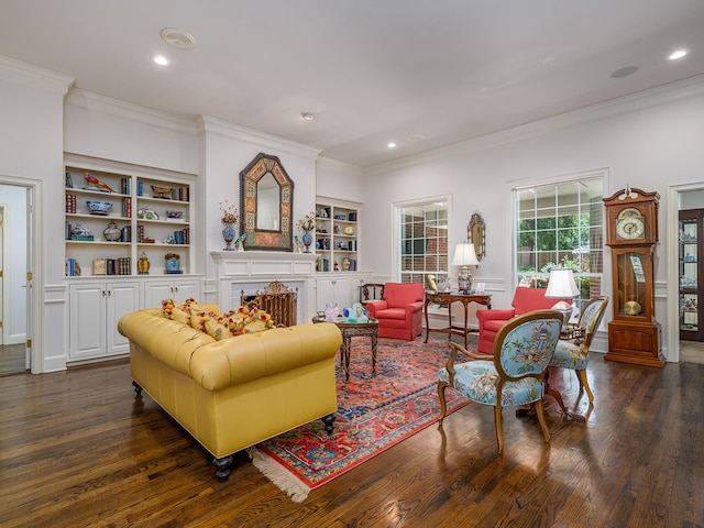 living room featuring ornamental molding, dark hardwood / wood-style flooring, and built in shelves