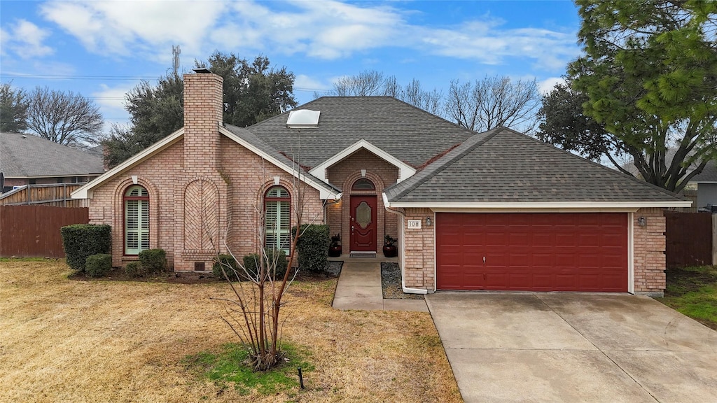 view of front of home featuring a garage and a front lawn