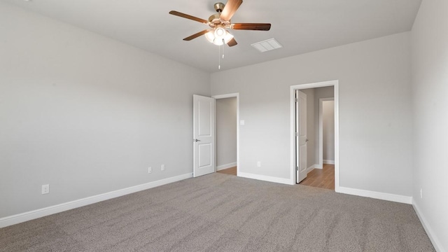 unfurnished bedroom featuring ceiling fan and light carpet