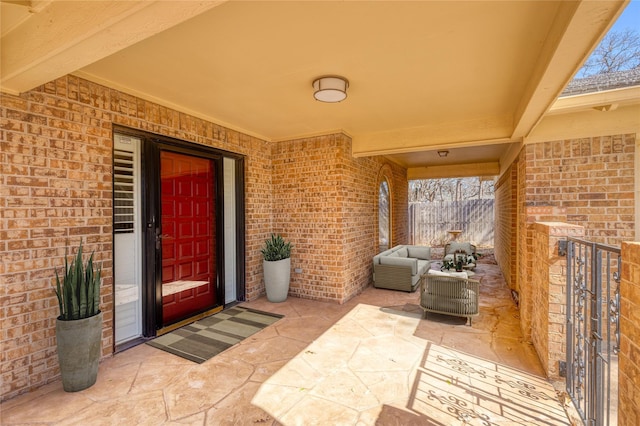 400 Driftwood Ct, Azle, TX 76020 - property entrance with brick siding, a patio area, and an outdoor living space