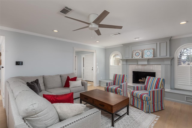 400 Driftwood Ct, Azle, TX 76020 - living room with a ceiling fan, crown molding, wood finished floors, recessed lighting, and a tiled fireplace