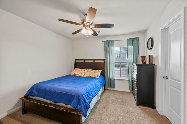 bedroom with ceiling fan and light carpet