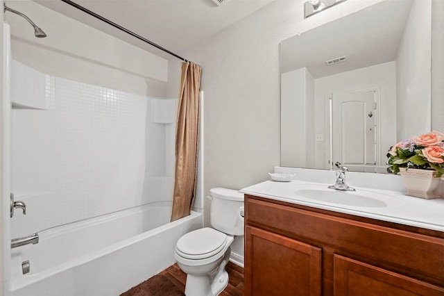 full bathroom featuring shower / tub combo, vanity, and toilet