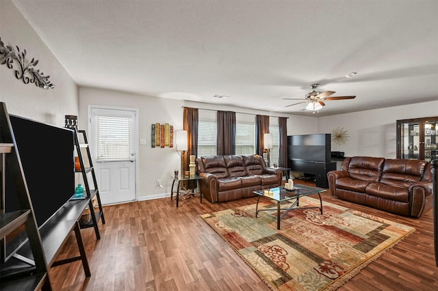 living room featuring hardwood / wood-style floors, a healthy amount of sunlight, and ceiling fan