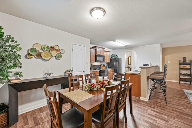 dining area with dark hardwood / wood-style floors