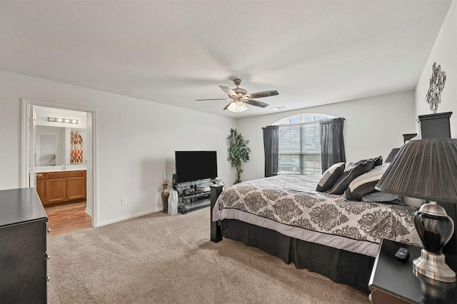 carpeted bedroom with connected bathroom and ceiling fan