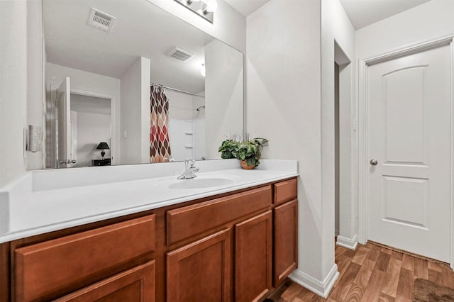 bathroom featuring vanity and hardwood / wood-style floors