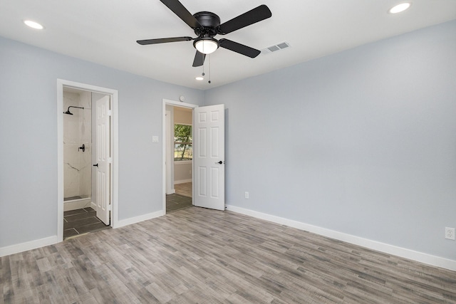 unfurnished bedroom with hardwood / wood-style floors, ceiling fan, and ensuite bathroom