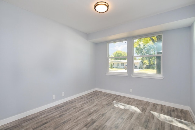 spare room with hardwood / wood-style flooring