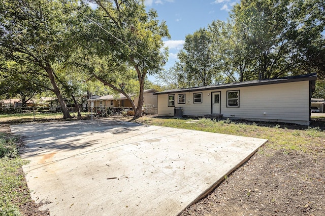 back of house with central AC unit