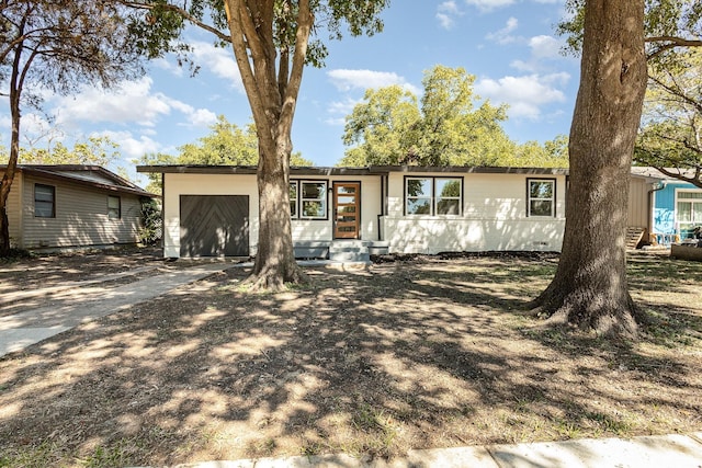 ranch-style home featuring a garage