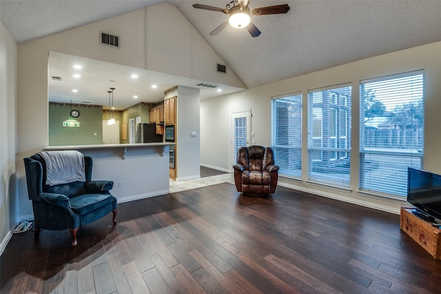 sitting room featuring ceiling fan, dark wood-style flooring, visible vents, and baseboards