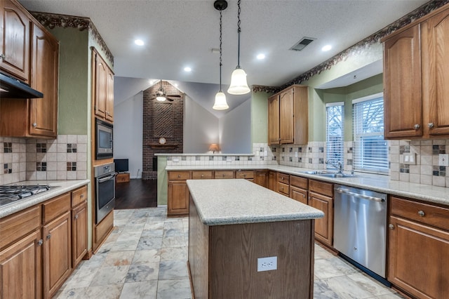 kitchen featuring light countertops, appliances with stainless steel finishes, a kitchen island, and visible vents