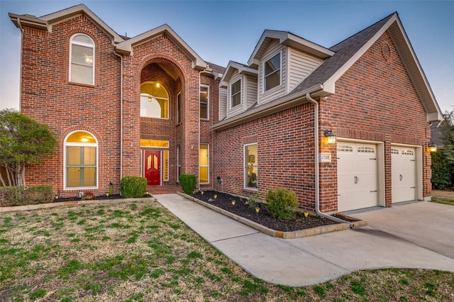 view of front of house featuring a garage, brick siding, and driveway