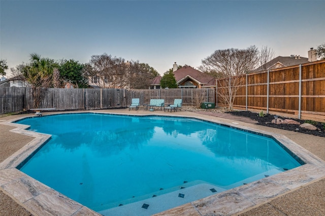 view of swimming pool with a fenced backyard and a fenced in pool