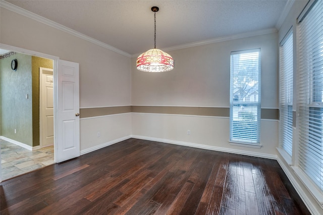 spare room with dark wood-style floors, crown molding, and baseboards