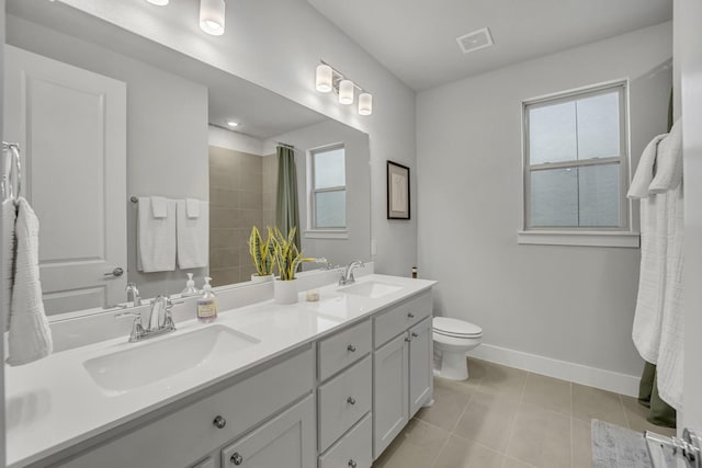 bathroom featuring tile patterned flooring, vanity, a shower with curtain, and toilet