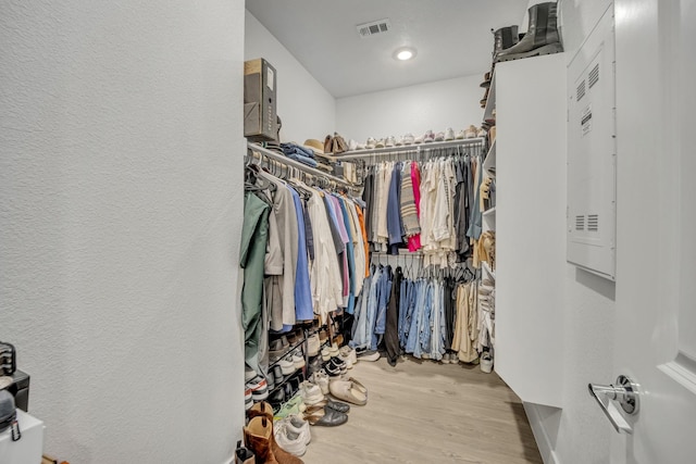 walk in closet with light wood-type flooring