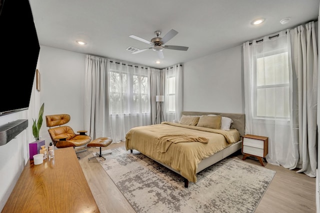 bedroom with ceiling fan and light hardwood / wood-style flooring