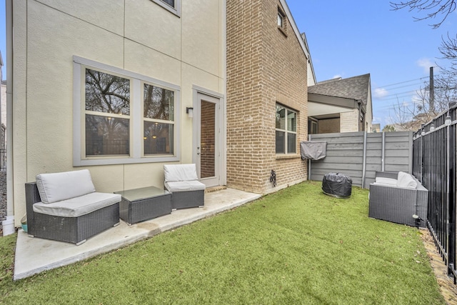 rear view of property featuring a yard, an outdoor hangout area, and a patio