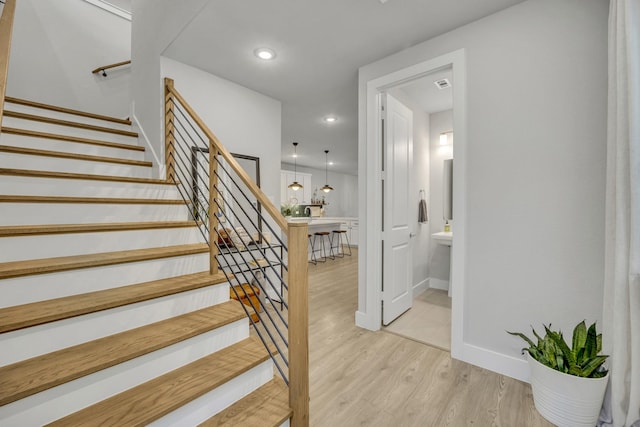 stairs with hardwood / wood-style flooring