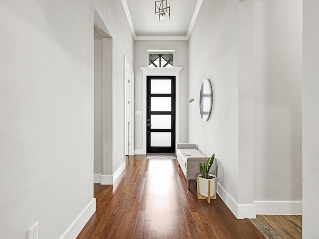 doorway with dark hardwood / wood-style flooring and ornamental molding