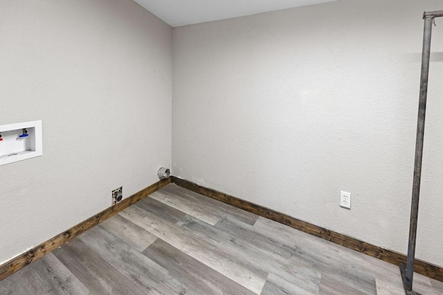 washroom with hardwood / wood-style flooring and washer hookup