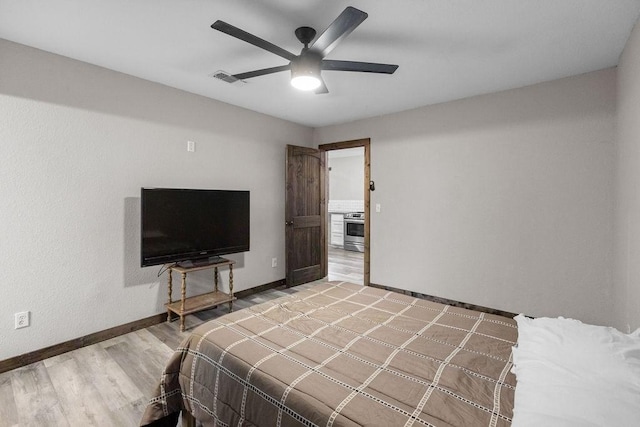 bedroom featuring hardwood / wood-style floors and ceiling fan