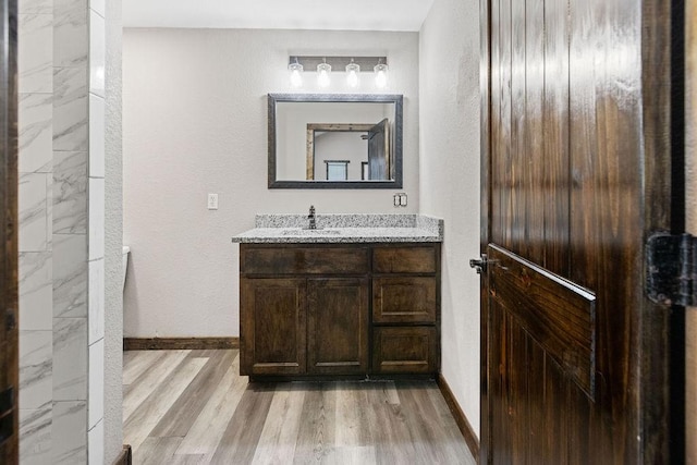 bathroom with vanity and hardwood / wood-style floors