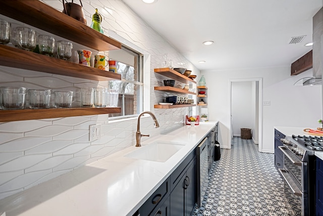kitchen featuring sink, decorative backsplash, and stainless steel appliances