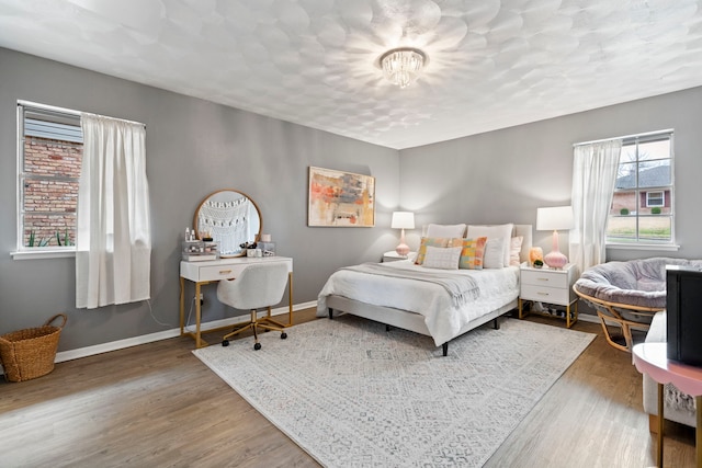 bedroom with wood-type flooring