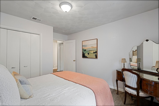 bedroom with hardwood / wood-style floors and a closet