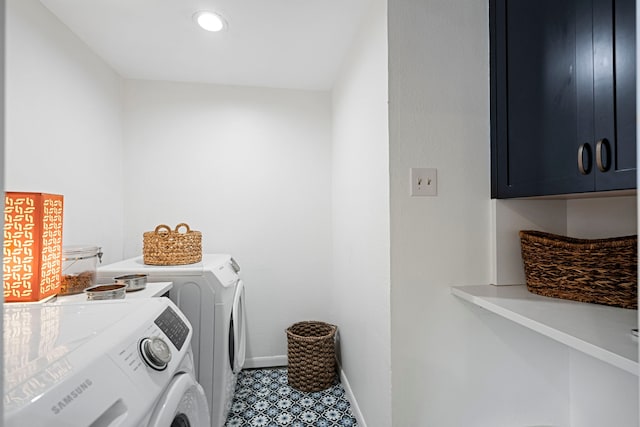 washroom with cabinets and washing machine and clothes dryer