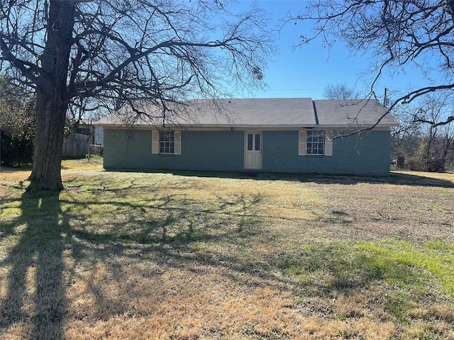 rear view of property featuring a yard