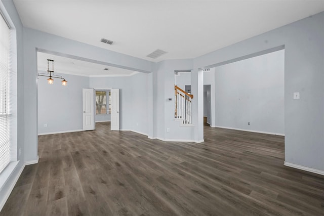 unfurnished living room featuring dark hardwood / wood-style floors