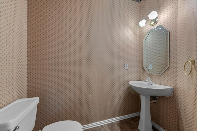 bathroom featuring hardwood / wood-style flooring and toilet