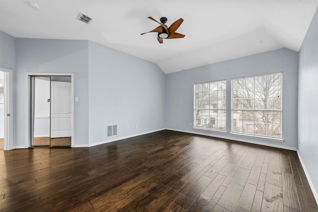 spare room with vaulted ceiling, dark wood-type flooring, and ceiling fan