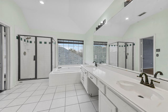 bathroom with tile patterned flooring, vanity, vaulted ceiling, and separate shower and tub