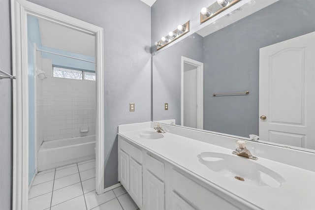 bathroom with vanity, tiled shower / bath combo, and tile patterned flooring