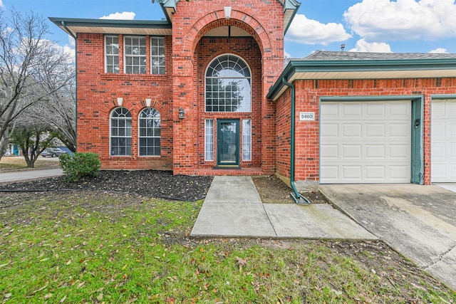 exterior space featuring a garage and a front yard