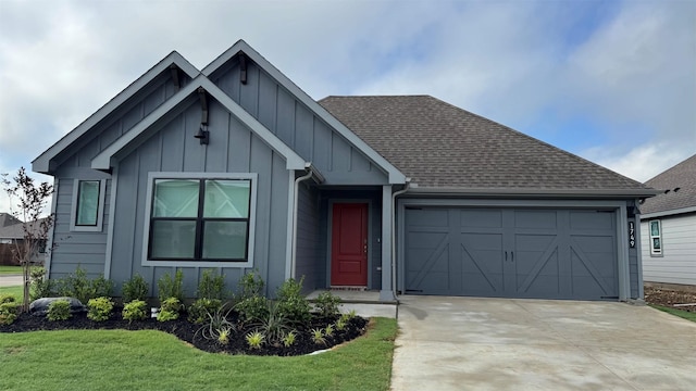 1749 River Bend Rd, Burleson, TX 76028 - view of front of house with board and batten siding, an attached garage, concrete driveway, roof with shingles, and a front yard