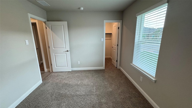 1749 River Bend Rd, Burleson, TX 76028 - unfurnished bedroom with multiple windows, carpet flooring, a spacious closet, and baseboards
